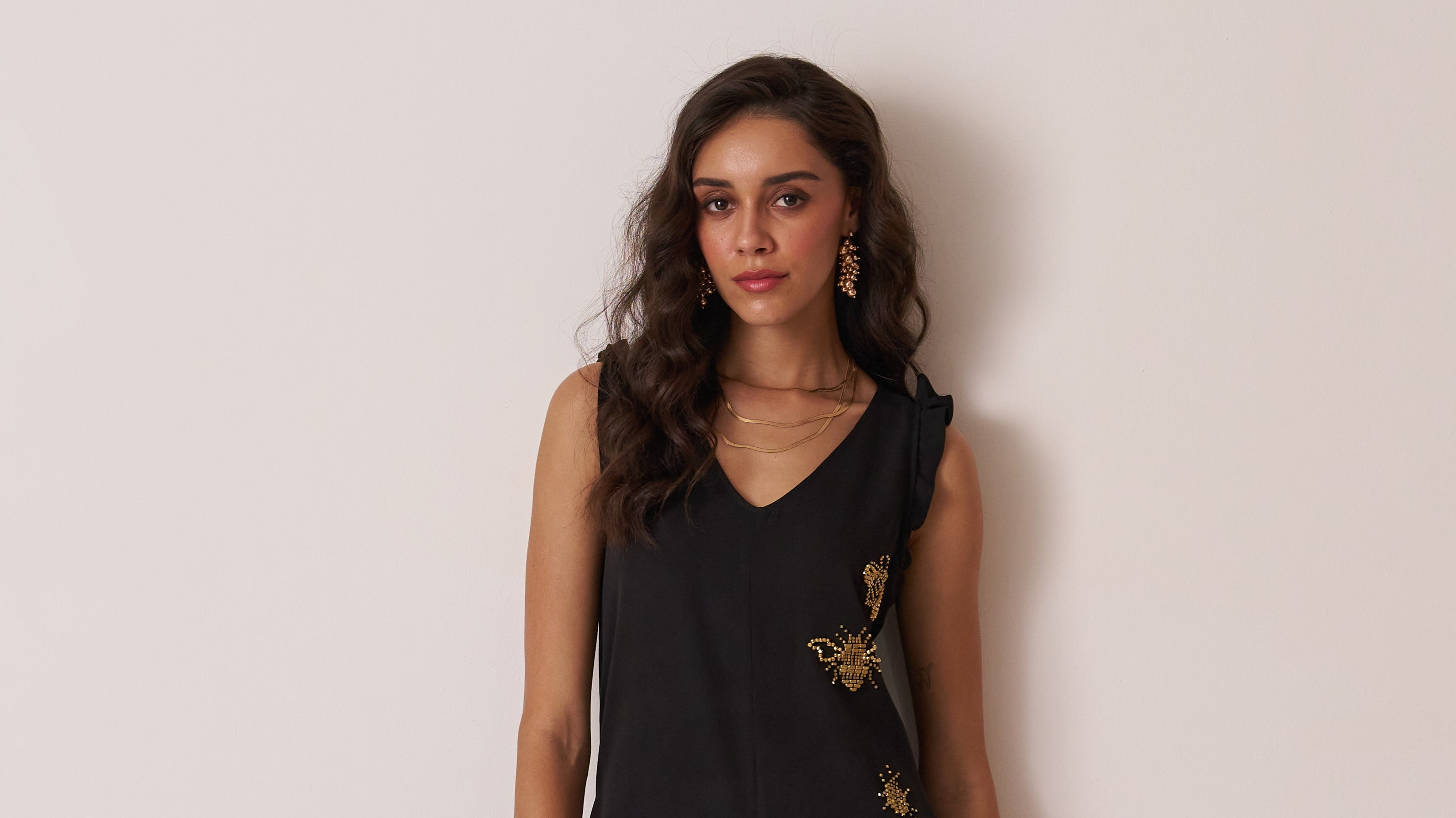 black jumpsuit with insect motif